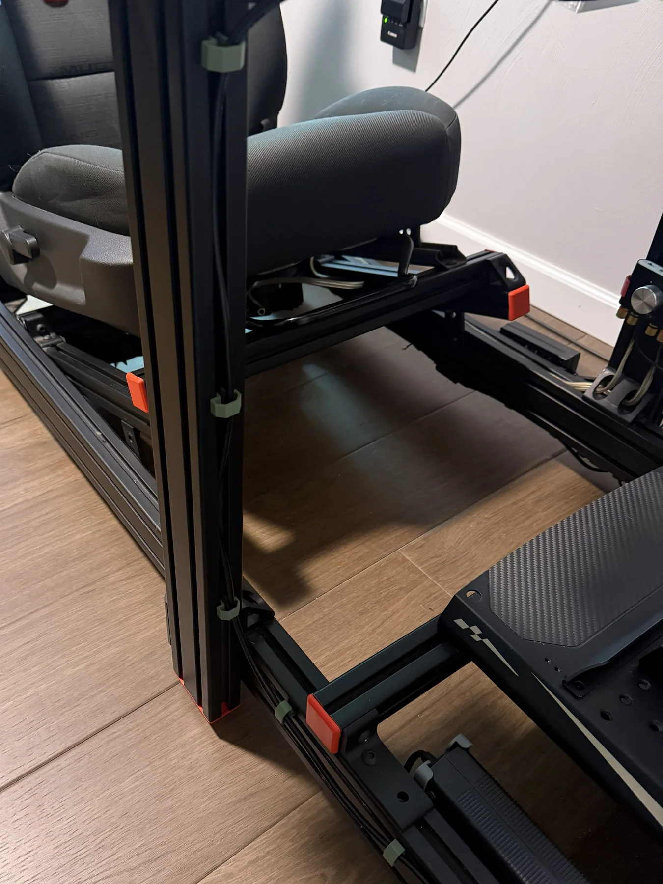 RouteClip cable management clips installed around an aluminum-extrusion simulator rig