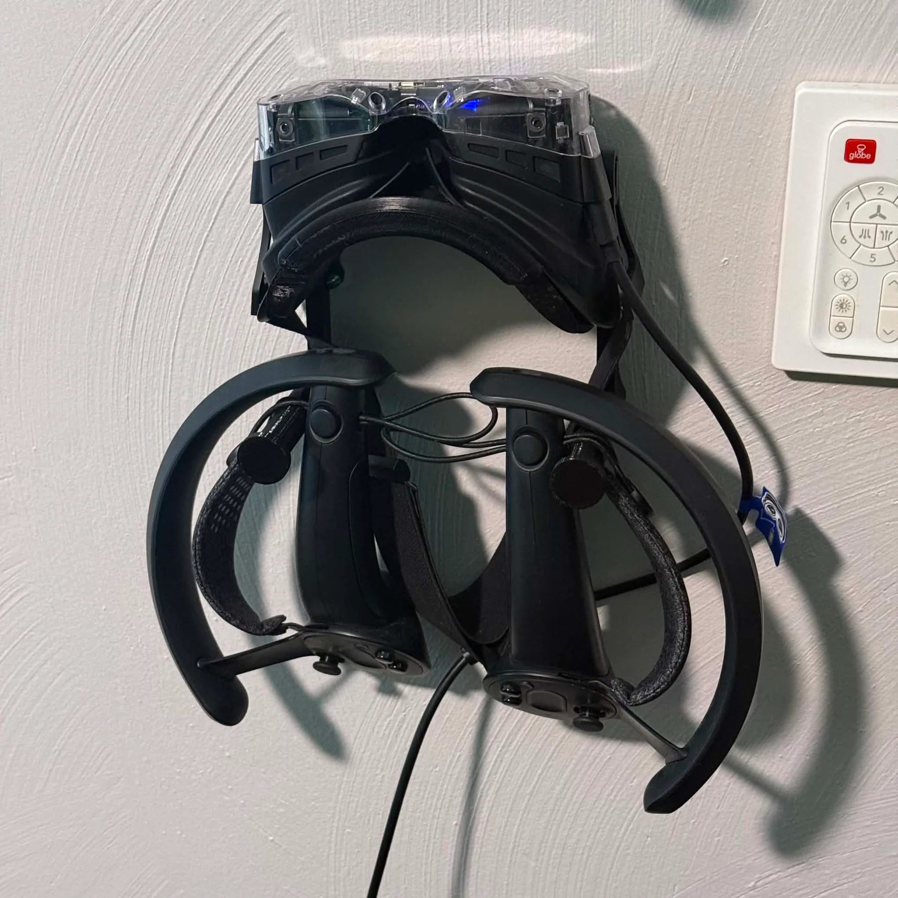 Bigscreen Beyond 2e headset and two Valve Index Controllers stored on the KT-14 wall mount