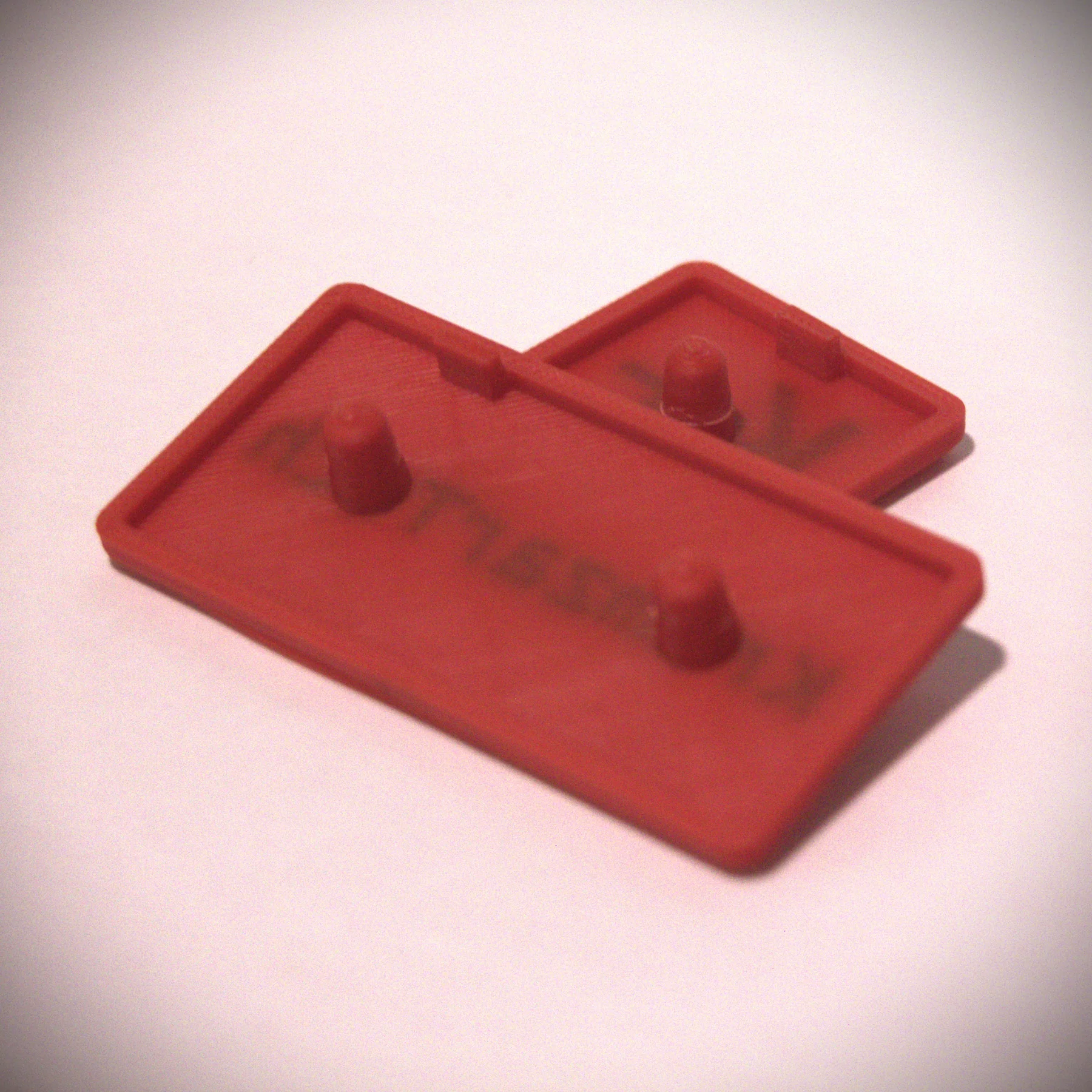 Rear view of customized extrusion end caps showing the anti-rotation indexing features